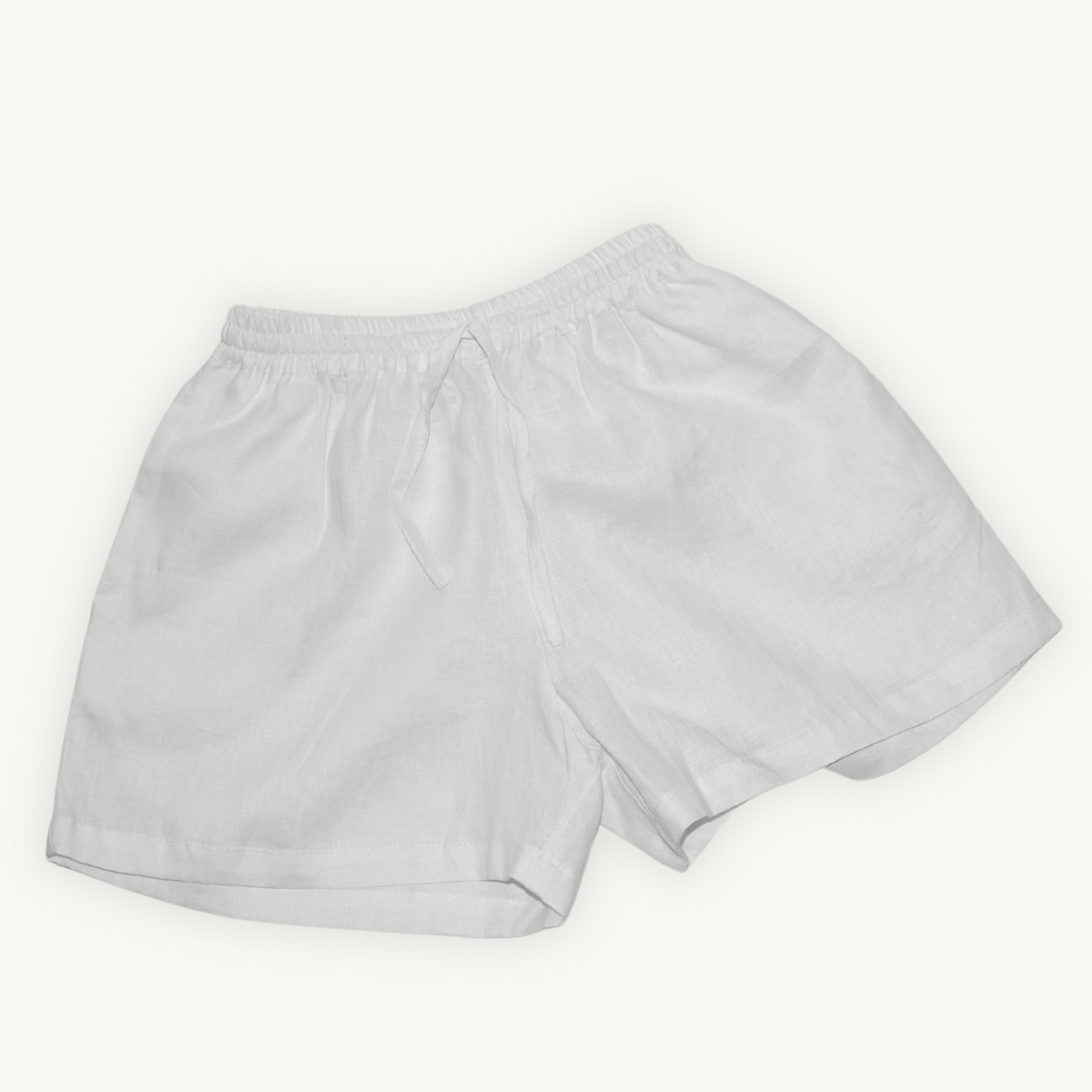 Pure white 2-inch linen shorts, crafted from lightweight, breathable fabric, ideal for casual and summer wear.