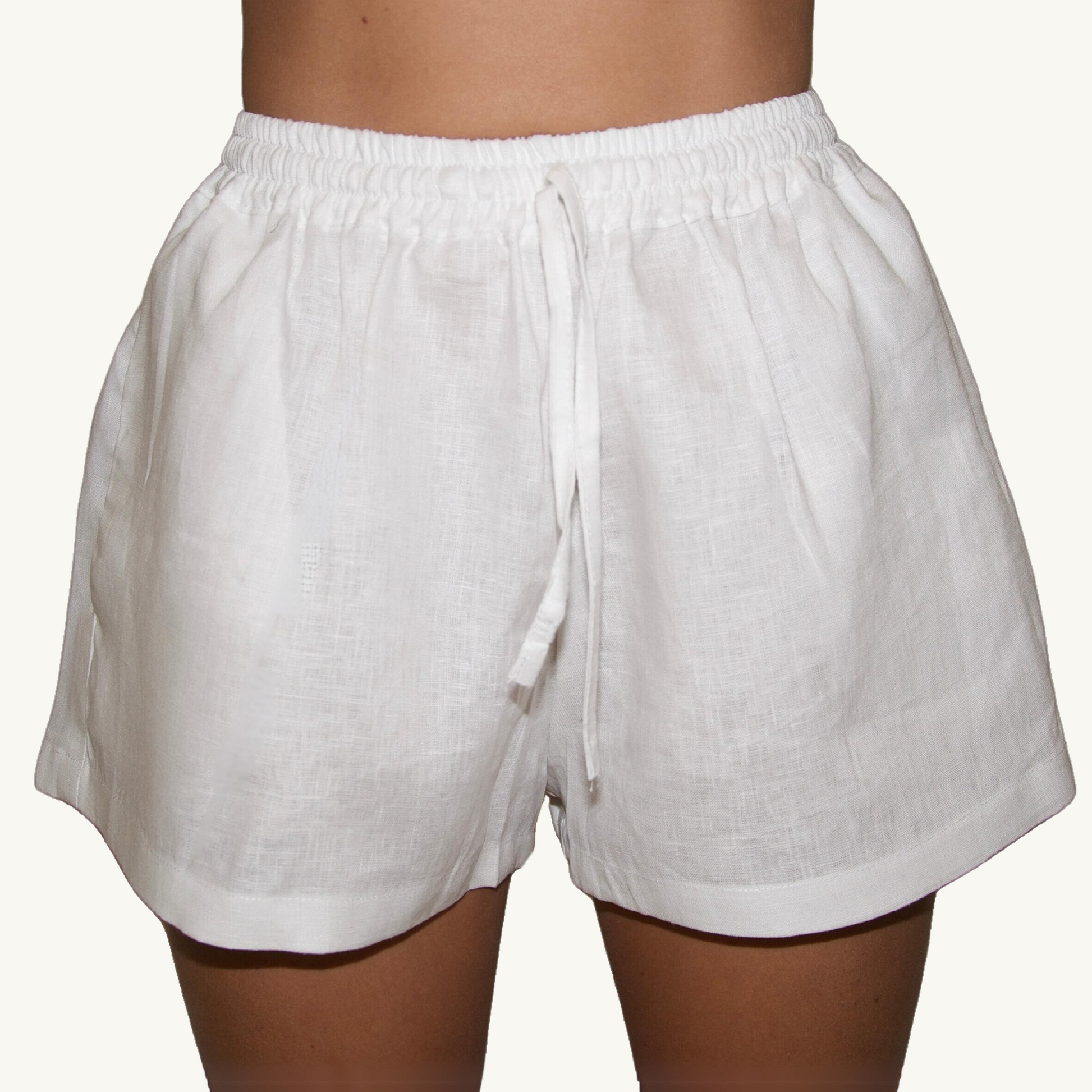 Pure white 2-inch linen shorts, crafted from lightweight, breathable fabric, ideal for casual and summer wear.